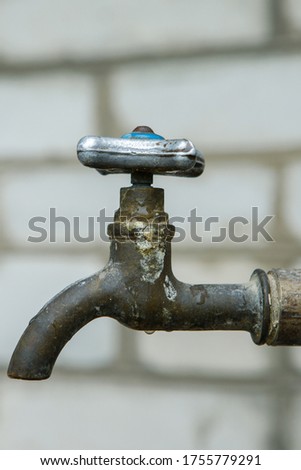 Old water tap,
typical crane on wall background