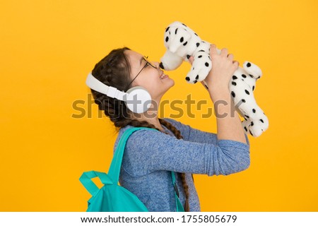 Cute smiling schoolgirl carry soft toy dog. Girl little schoolgirl. Modern schoolgirl daily life. Private schooling. Diverse learning environments designed to meet the needs. Teen with backpack.