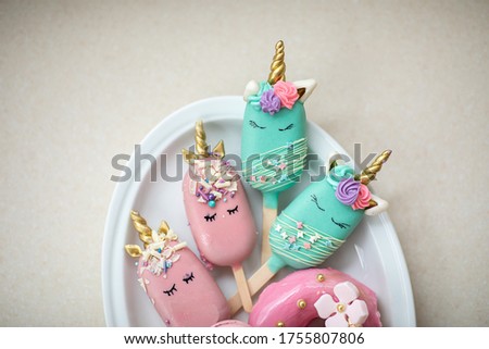 Sweets in the form of unicorns. Gingerbread cookies on a plate. Image with selective focus.