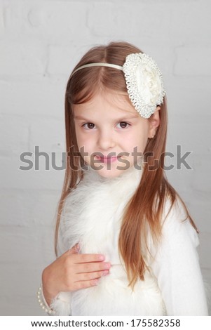 Image of adorable little kid with white hoop on the head