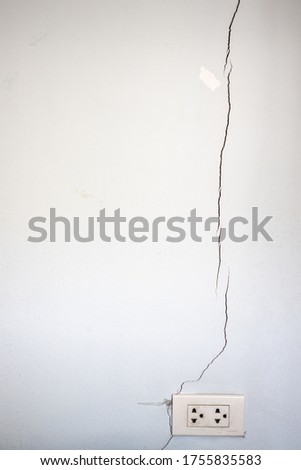 Cracks on old walls and electrical sockets