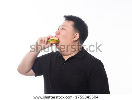 Young Funny Fat Asian man eating hamburger isolated on white background, Unhealthy concept.