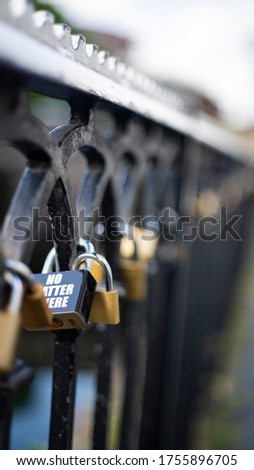promise locks on a sidewalk fence love locks