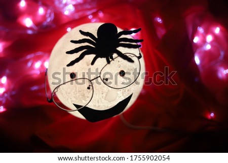 Spider on a cartoon faced light source horror photo 