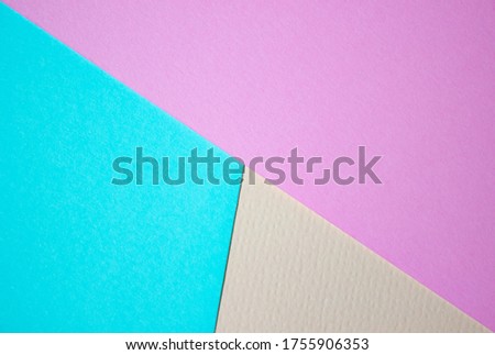 Multicolor background from paper of different colors, pink, blue and yellow. Concept lines, triangles, trapezoid.