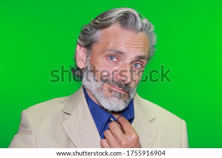 mature caucasian man in suit over green screen