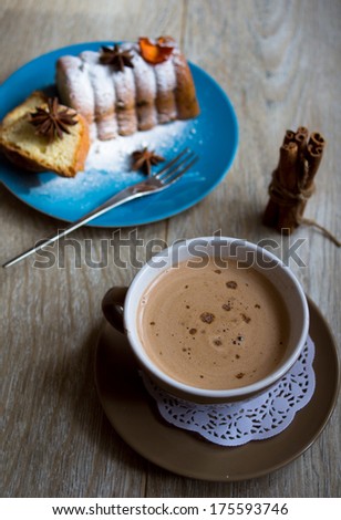 Cup of coffee with milk and sweets on the table