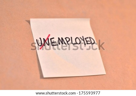 Text unemployed with un crossed out on the short note texture background