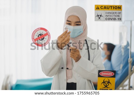 Young Asian woman Muslim doctor  preparing vaccine Covid-19 to give elderly patient sitting in bed at hospital which smiling and felling happy. Medicine Pandemic of corona virus, COVID19 concept.
