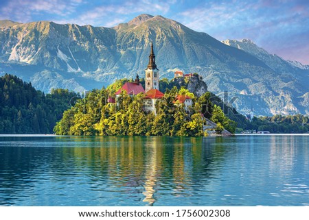 Sunrise ower Bled Lake, Island, Church And Castle With Mountain Range (Stol, Vrtaca, Begunjscica) In The Background-Bled, Slovenia Royalty-Free Stock Photo #1756002308