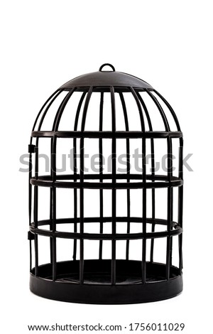 Trapped and captivity conceptual idea with black bird cage isolated on white background and clipping path cutout Royalty-Free Stock Photo #1756011029