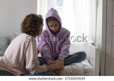 Caring Caucasian mother talk comfort unhappy sad teenage daughter suffering from school bullying or psychological problems, loving mom support make peace with depressed introvert teen girl child Royalty-Free Stock Photo #1756024634
