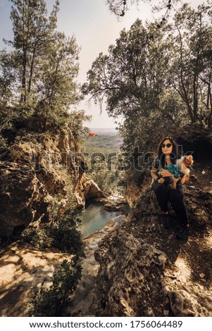 Traveller woman and her dog at King's pool in Turkey