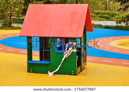 Toy house on the playground in autumn, close up