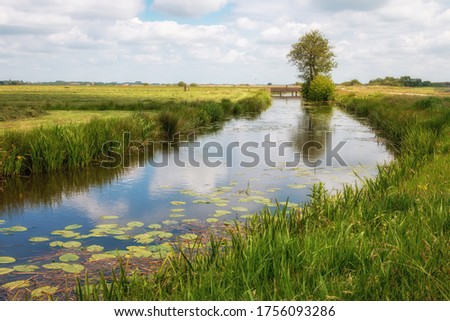The Netherlands a wet country full of ditches and canals, sailing boats and vast plains with grassland, photos taken in Friesland Gaasterland region Royalty-Free Stock Photo #1756093286