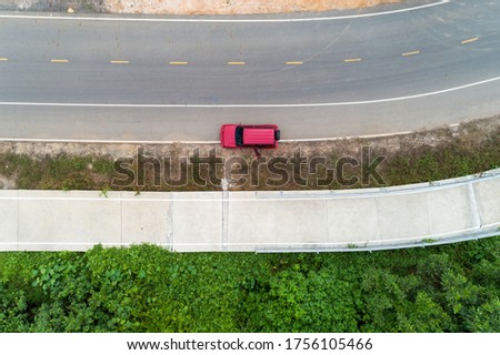 Aerial view photo high angle view top down of red suv car on road
