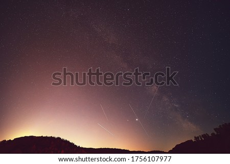 Summer Milky Way, Jupiter, Saturn, Mars planets and satellite light in the night sky.