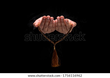 The image of a Muslim woman's hand, Islamic prayer, and her hand holding a rosary beads or tasbih. Royalty-Free Stock Photo #1756116962