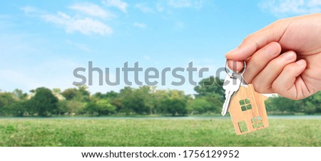 Real estate agent handing over a house keys in hand