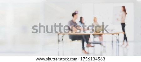 Abstract blurred interior modern office space with business people group working banner background with copy space.