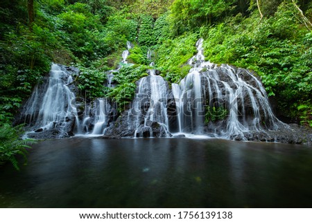 Amazing landscape. Beautiful hidden waterfall in tropical rainforest. Adventure and travel concept. Nature background. Slow shutter speed, motion photography. Pucak Manik waterfall Bali, Indonesia