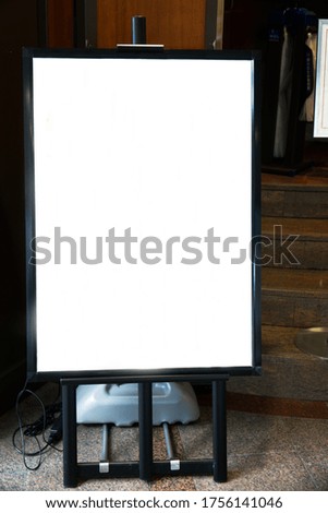 Blank mock up of vertical street poster billboard on in front of wooden retro and vintage storefront background