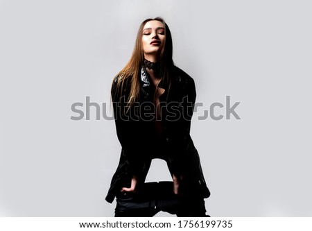 Beautiful young woman in black dress looking away. Studio shot Isolated on gray. Stylish clothing outfit. Fashion look Royalty-Free Stock Photo #1756199735
