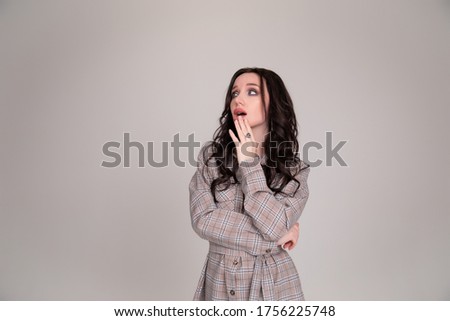 Beautiful girl student business woman thought on gray or white background