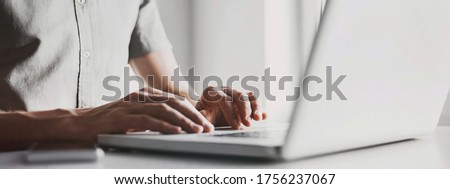 Young man working on computer at home. Businessman using laptop in office. Business, online learning, internet marketing, freelance, studying, distance education concept. Panoramic banner