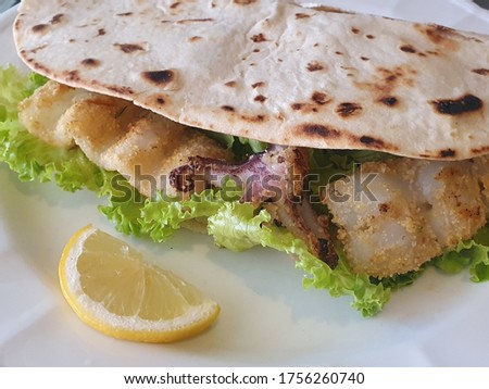 typical Italian bread with squid and salad