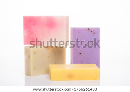 Organic lemon orange coffee herbs aloe soap bars concept. Photo of variety of homemade colorful soap bars isolated on white background