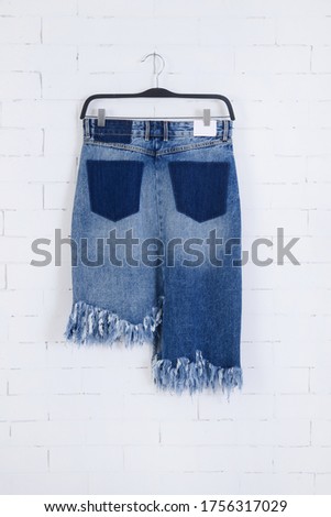 Women's Blue jeans shorts on wall background-back view 


