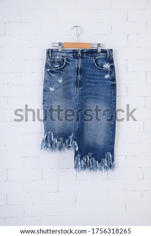 
Women's Blue jeans shorts on hanging - wall background-back view 


