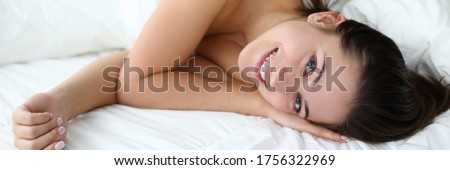 Beautiful girl woke up in good mood and smiling. Improve sleep quality feel fresh, alert and full energy. Develop habit getting up early. Comfortable bed at hotel. Wake up right and start your brain Royalty-Free Stock Photo #1756322969