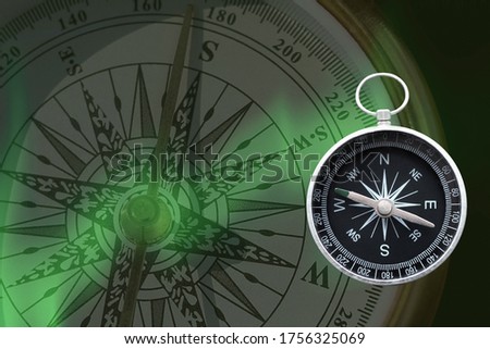 round compass on background of another compass