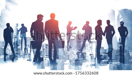 Silhouettes of diverse businessmen working together in abstract blurry city. Concept of teamwork and communication. Toned image double exposure
