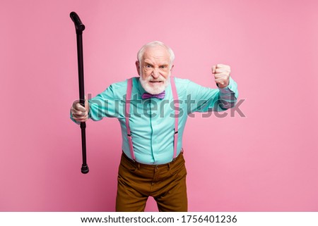Photo of mad aged man raise walking cane fist angry grimace blaming neighbor kids for noisy behavior wear shirt suspenders bow tie trousers isolated pink pastel background Royalty-Free Stock Photo #1756401236