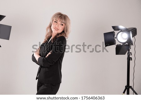 Business woman in photo studio with lamps