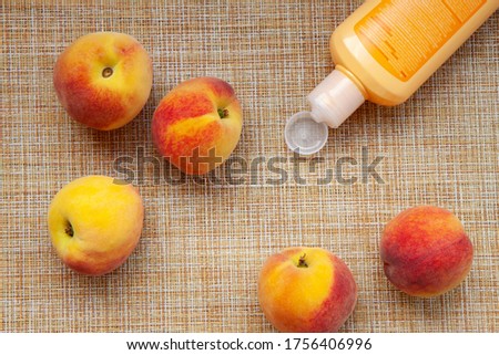 cream for self-care from peach extract, peaches on a kitchen napkin