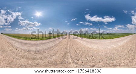 Full spherical seamless hdri panorama 360 degrees angle view on no traffic white sand gravel road among fields with clear sky with beautiful clouds in equirectangular projection, VR AR content