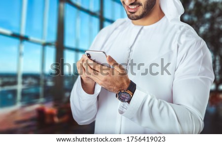 Businessman working on the smartphone
Close up of a business man using mobile smart phone, office background.