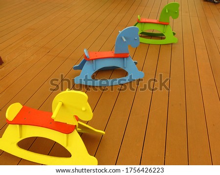 many colorful children rocking horses for decoration and playground concept  
Retro photo effect