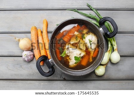 Top view of chicken soup on wooden table Royalty-Free Stock Photo #175645535