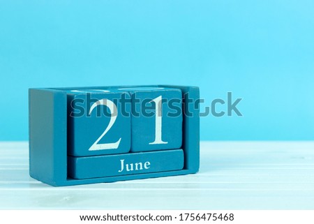 wooden calendar with the date of June 21 on a blue wooden background, , World Hydrography Day, World Giraffe Day, World Handshake Day, Fathers Day