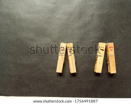 two pair of smiley wooden clips in happy mood, daylight, bright.