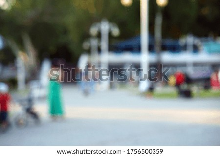 Blurred abstract background. City square with people.