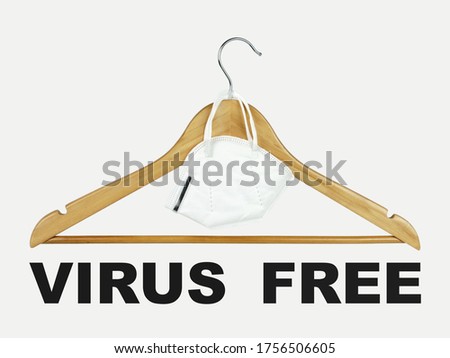 wooden clothes hanger with medical mask and the inscription "Virus Free" on a white background