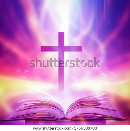 The Christian Cross is illuminated in a book in white and fantasy light, with magic shining as hope, love and freedom in beautiful illustrations.