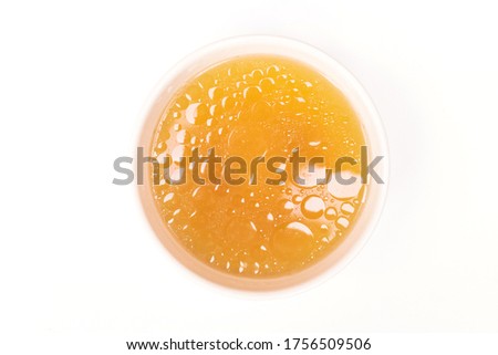 Bowl of chicken broth isolated on white background.