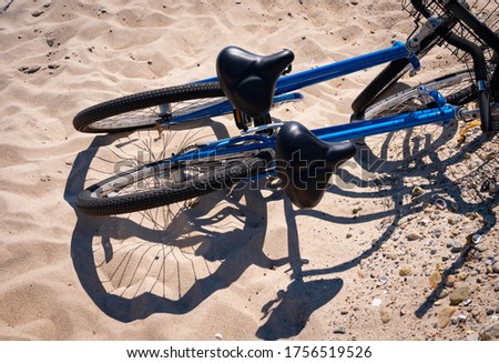 Two bikes on the beach. Abstract shapes and shadows. View from the top.